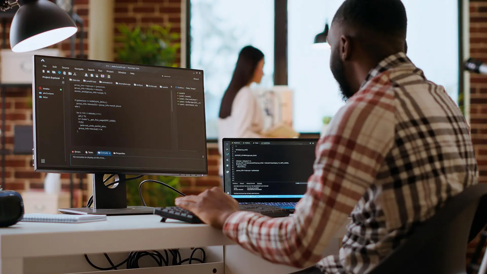 it professional types programming code on dual monitors